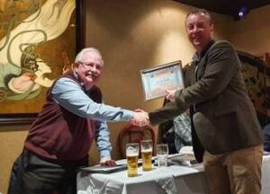 The new Club Chairman receives his certificate.